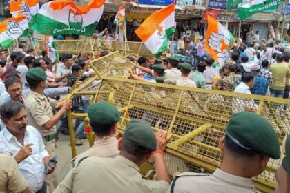 Congress workers break police barricade during a protest against the union government over alleged misuse of central agencies to target opposition leaders, in Agartala, Tuesday. (PTI Photo)